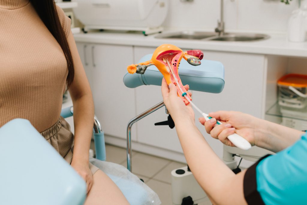 Gynecologist demonstrates intrauterine device IUD insertion using ...